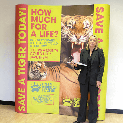 A woman standing beside a Pop-Up Display Poster