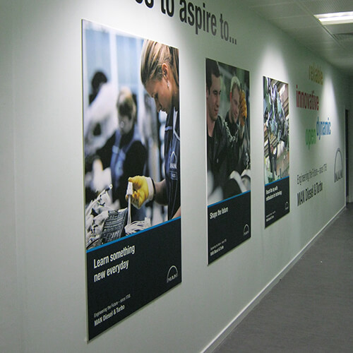 Large format printed posters hanging on the wall