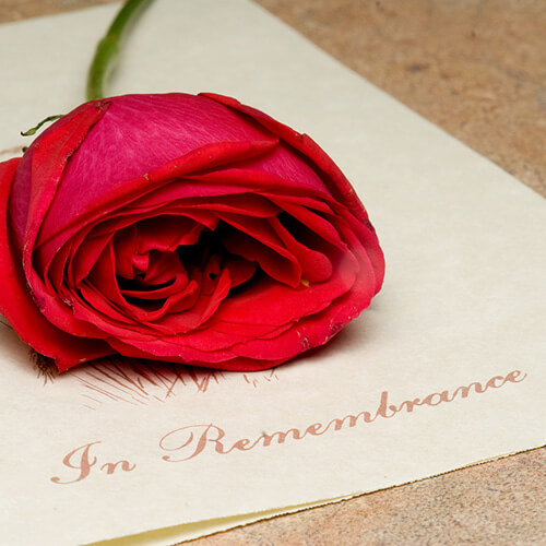 A card with red rose on top