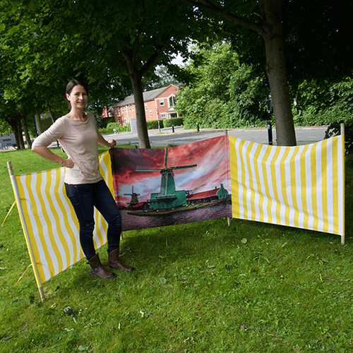 A woman posing beside a Breeze Windbreak