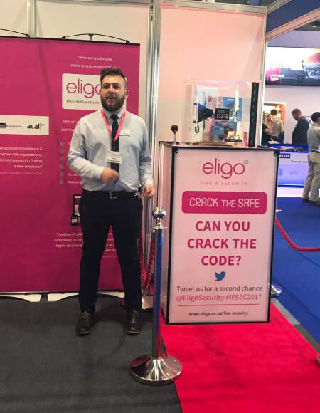 a man standing beside a red carpet in an Eligo event