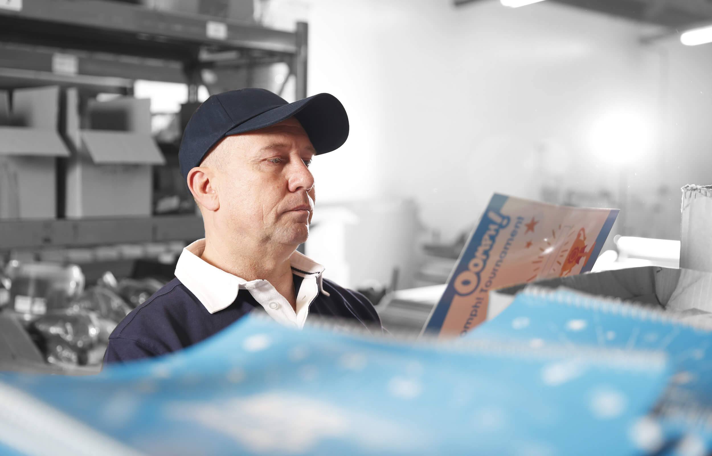 a wimbledon studio employee looking at a print result 