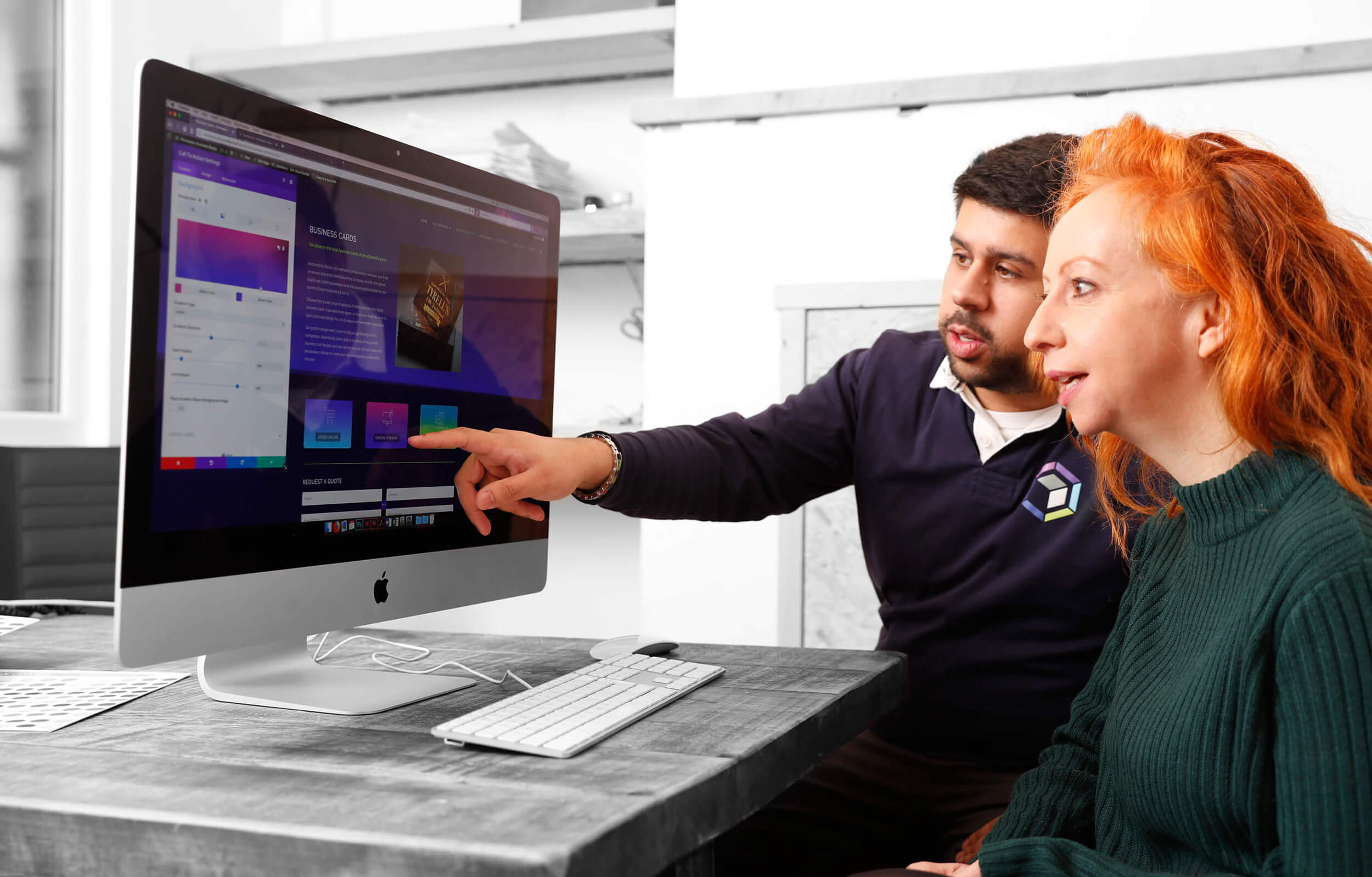 a man and a woman looking on the monitor