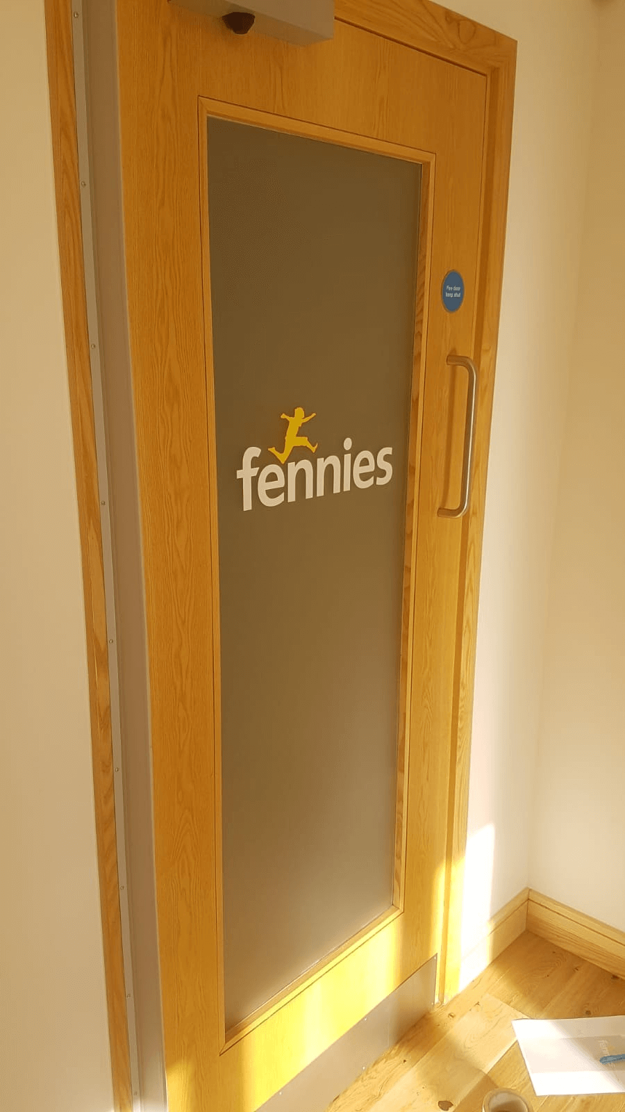 a door with fennies nurseries logo design